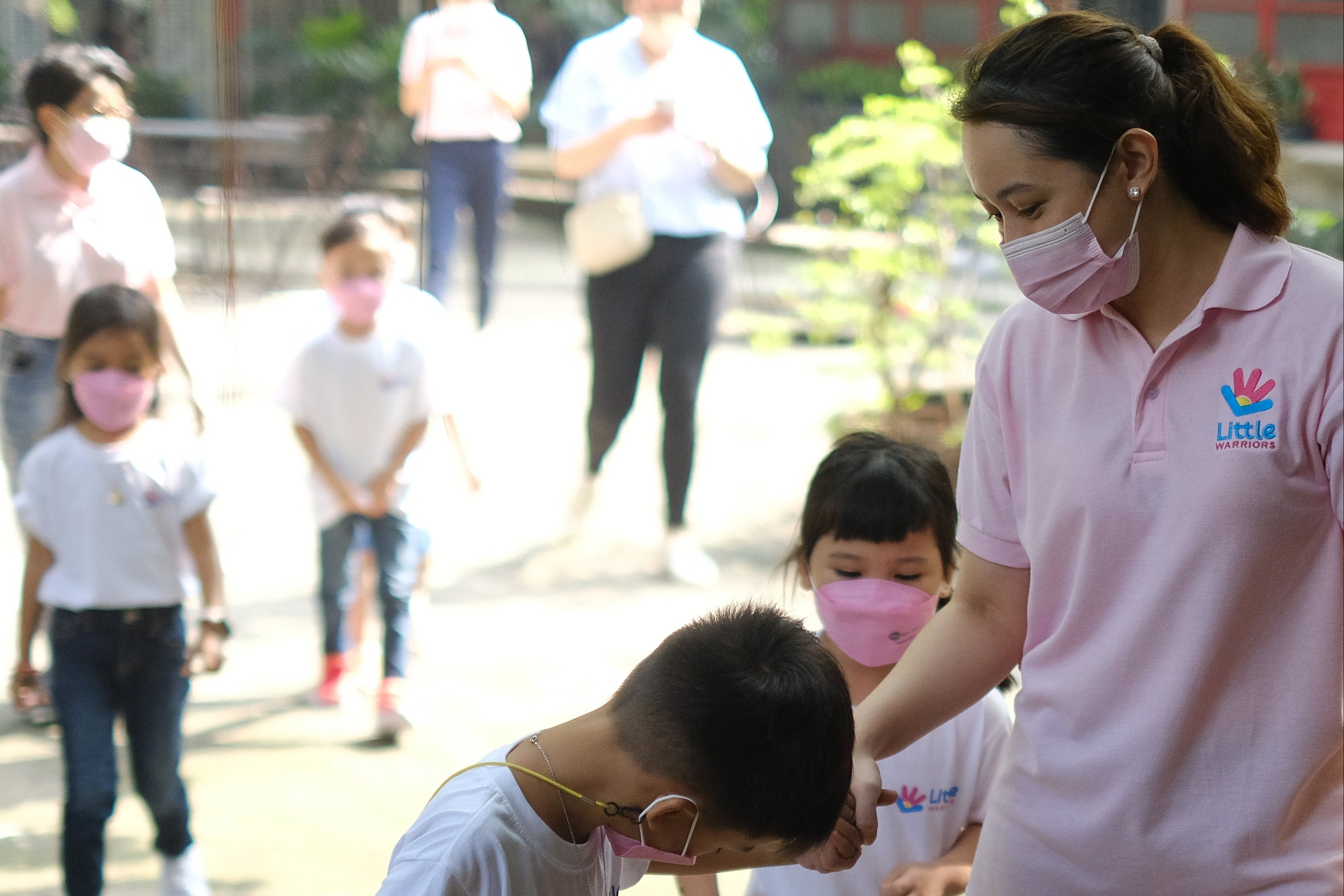 Preschool teacher guiding students / Little Warriors Preschool's Miranda Avellana (Teacher Mimi) guides the children.