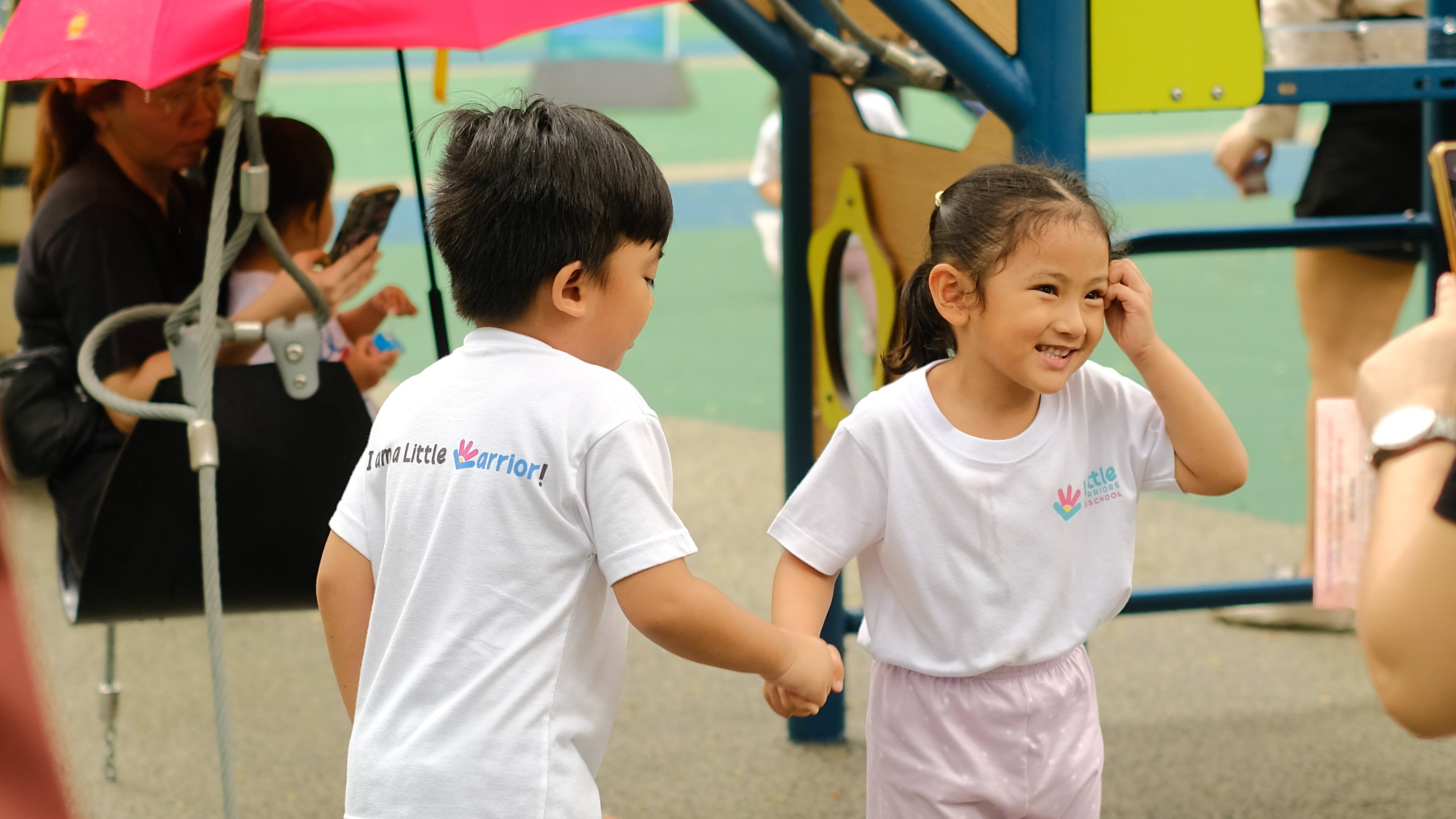 Little Warriors Preschool students hold hands at Ayala Triangle Play Forest in Makati City. / Children smiling and having fun.