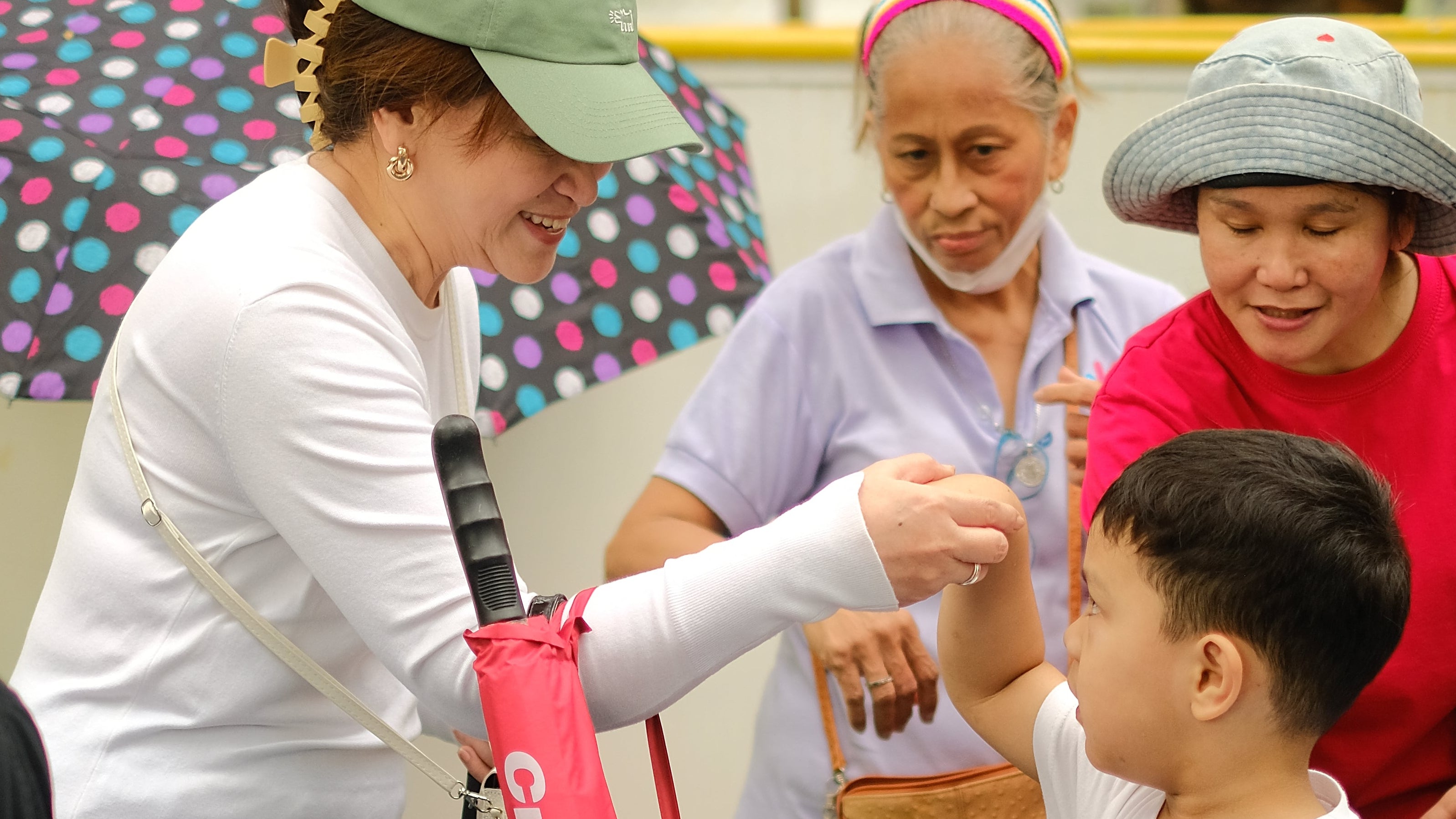 Pagmamano / Child bows and presses his forehead to the back of an elder's hand. Little Warriors Preschool's student greeting the investor, Teri Avellana.