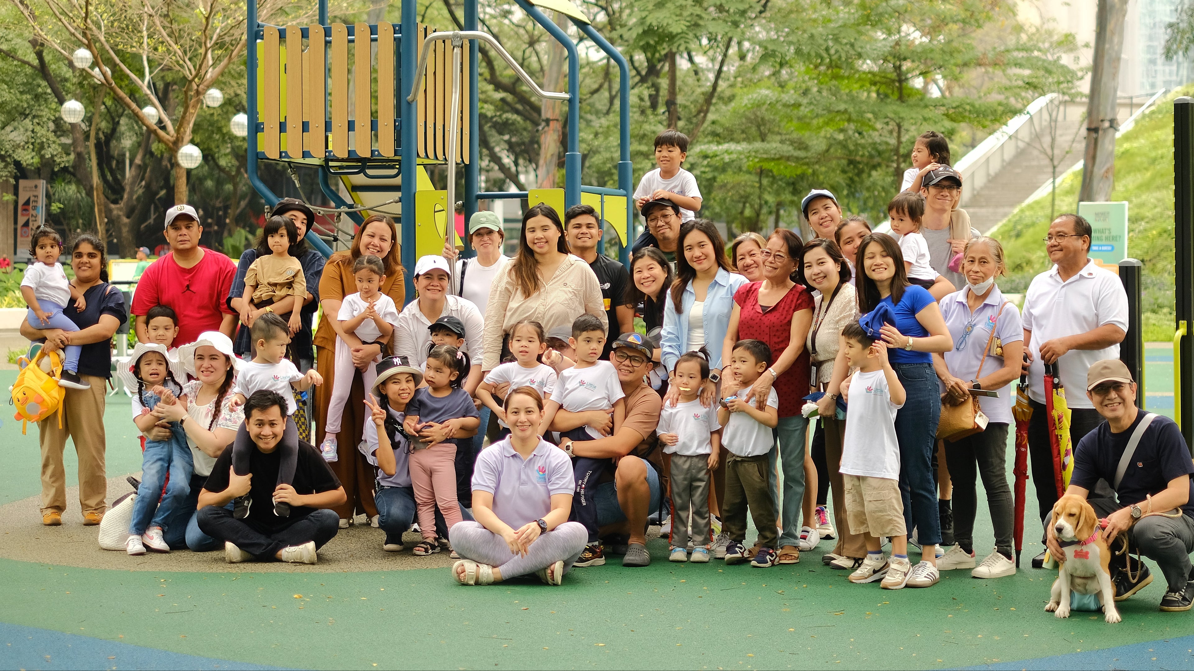 The Little Warriors Preschool community of parents, guardians, and children/students with teachers posing for a group picture at Ayala Triangle in Makati City.