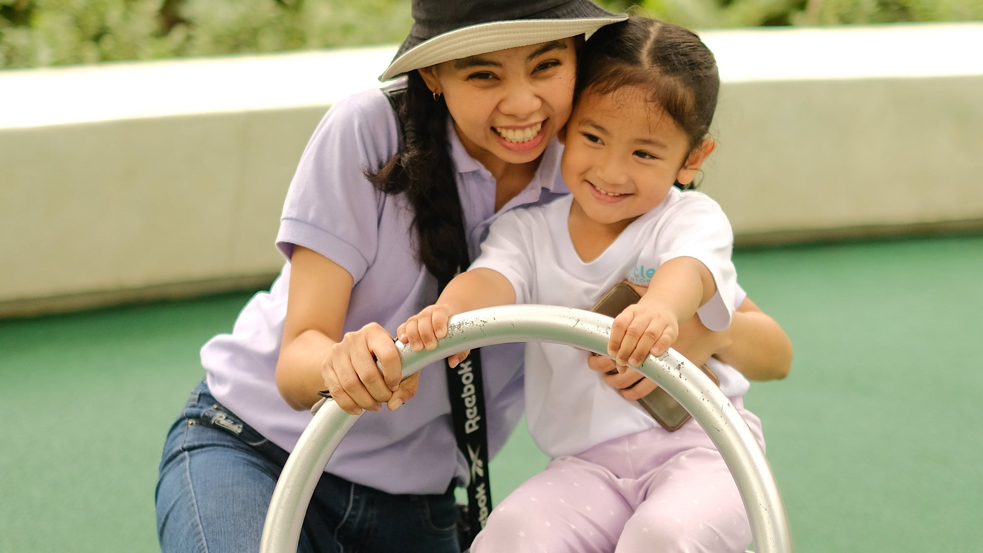 Preschool teacher of Little Warriors Preschool plays with a nursery student at Ayala Triangle, Makati City.